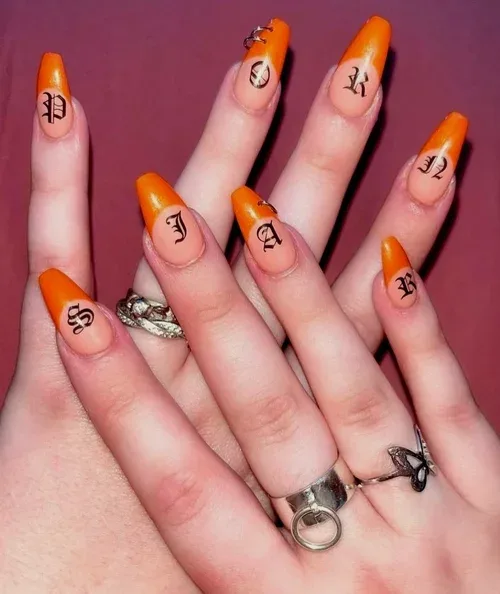 Orange Monogram nail art — orange coffin nails with Old-English monogram letters